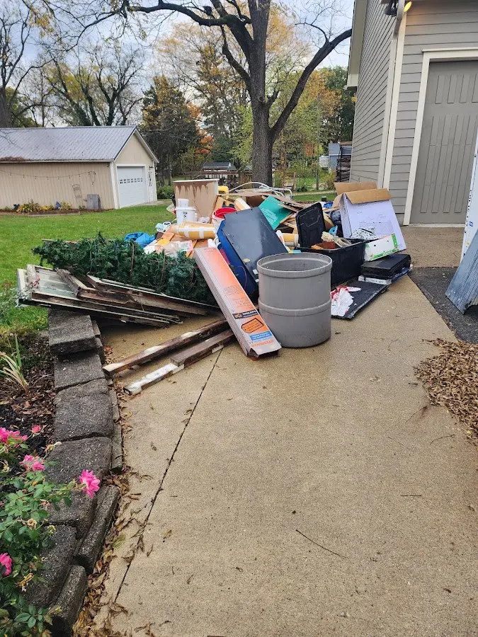 Dumpster being loaded with debris for 12 Yard Dumpster Rental in Rio Rico